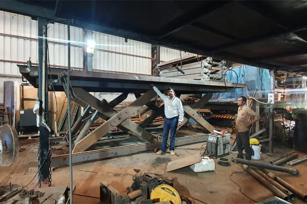 Heavy scissor assembly under fabrication on the shop floor